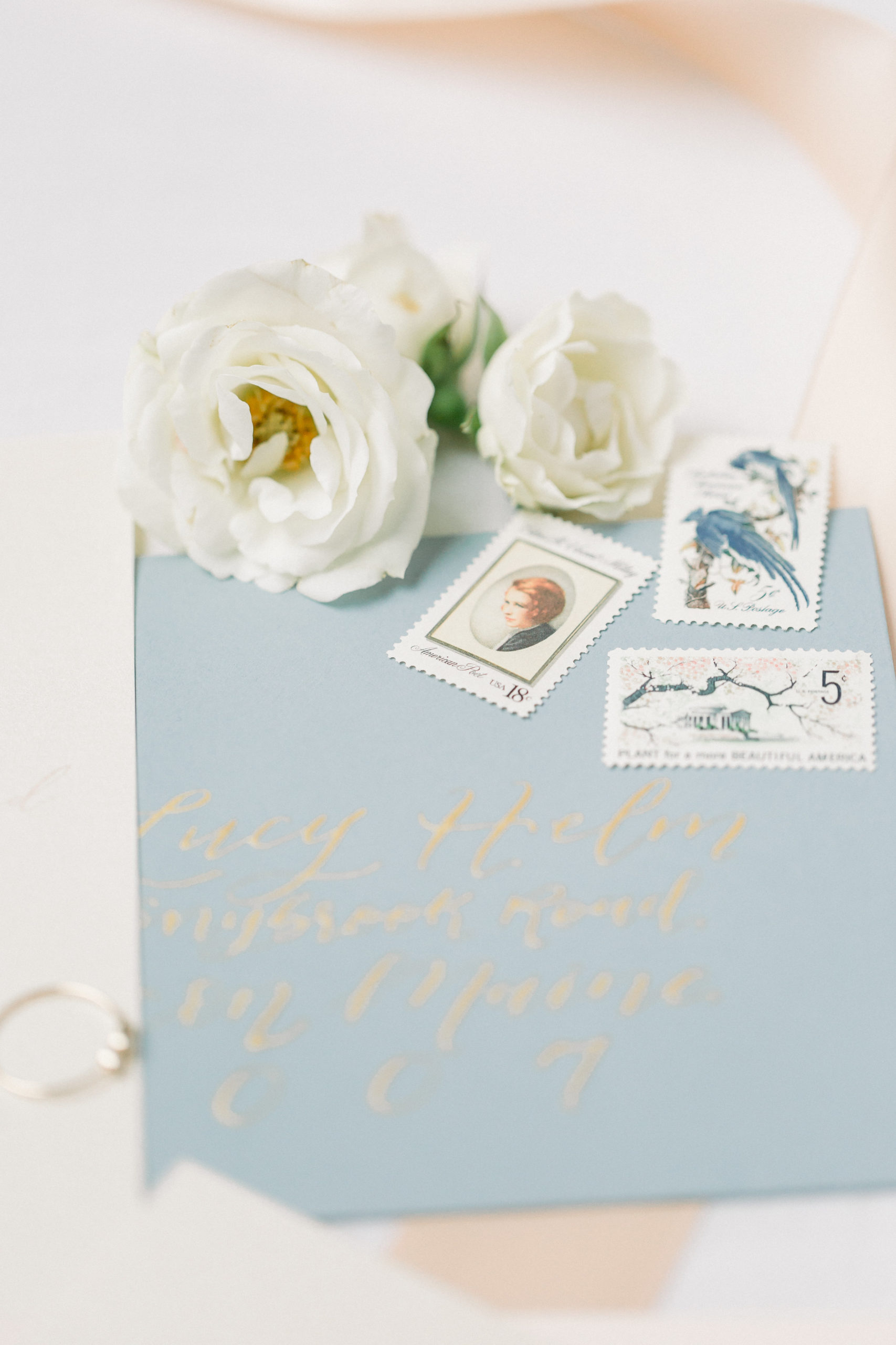 Pricing Postage for Wedding Invitations Dusty Blue Envelope with Gold Calligraphy and Vintage Postage